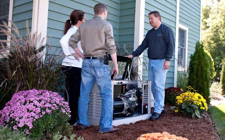 Homeowner looking at a backup generator with a specialist