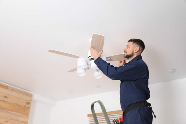 Man installing a brand new ceiling fan.
