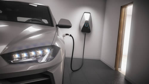 An electric vehicle charging station installed in a garage
